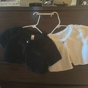 Girls white and black faux fur shrugs.